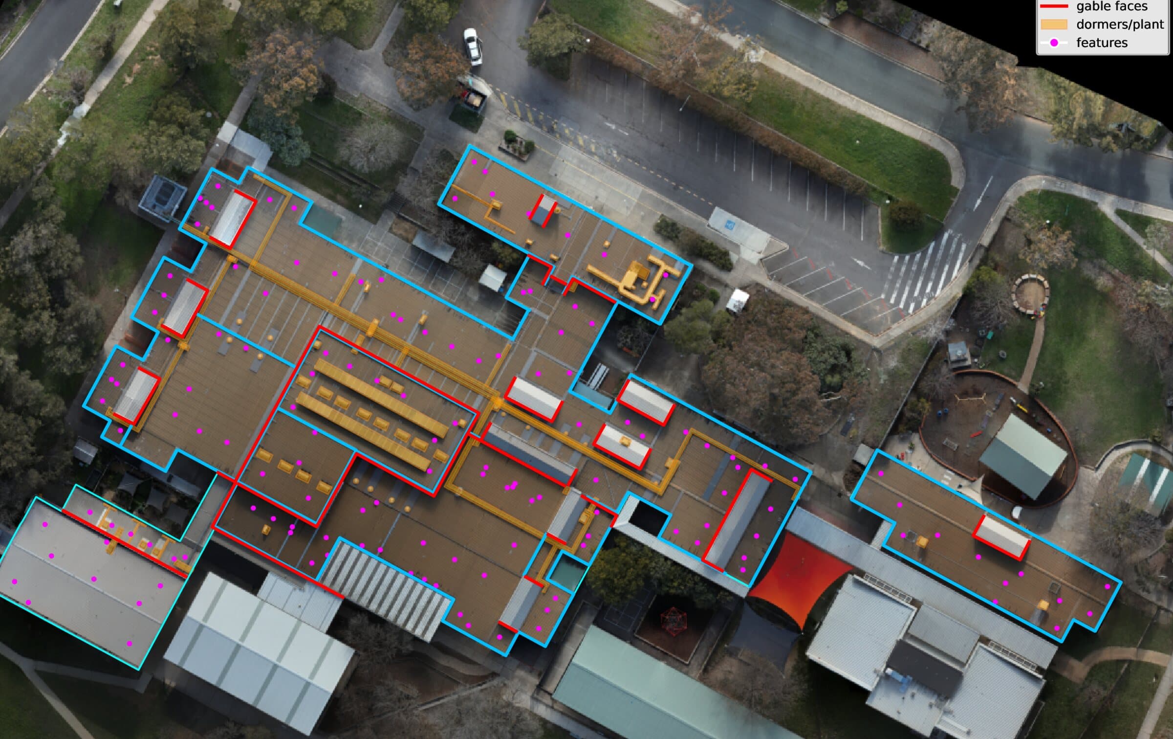 Roof detail with box gutters, gable faces, and plant and penetrations picked out in colour